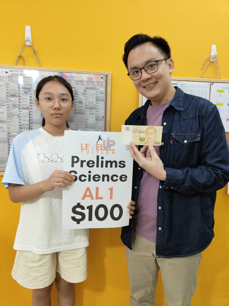 LevelUp Tuition student receives a cash reward for achieving AL1 in Prelims Science, standing with Kydon.