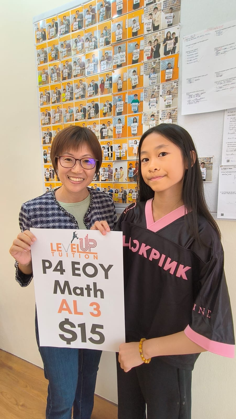 Chloe holding her LevelUp Tuition P4 EOY Math AL3 reward