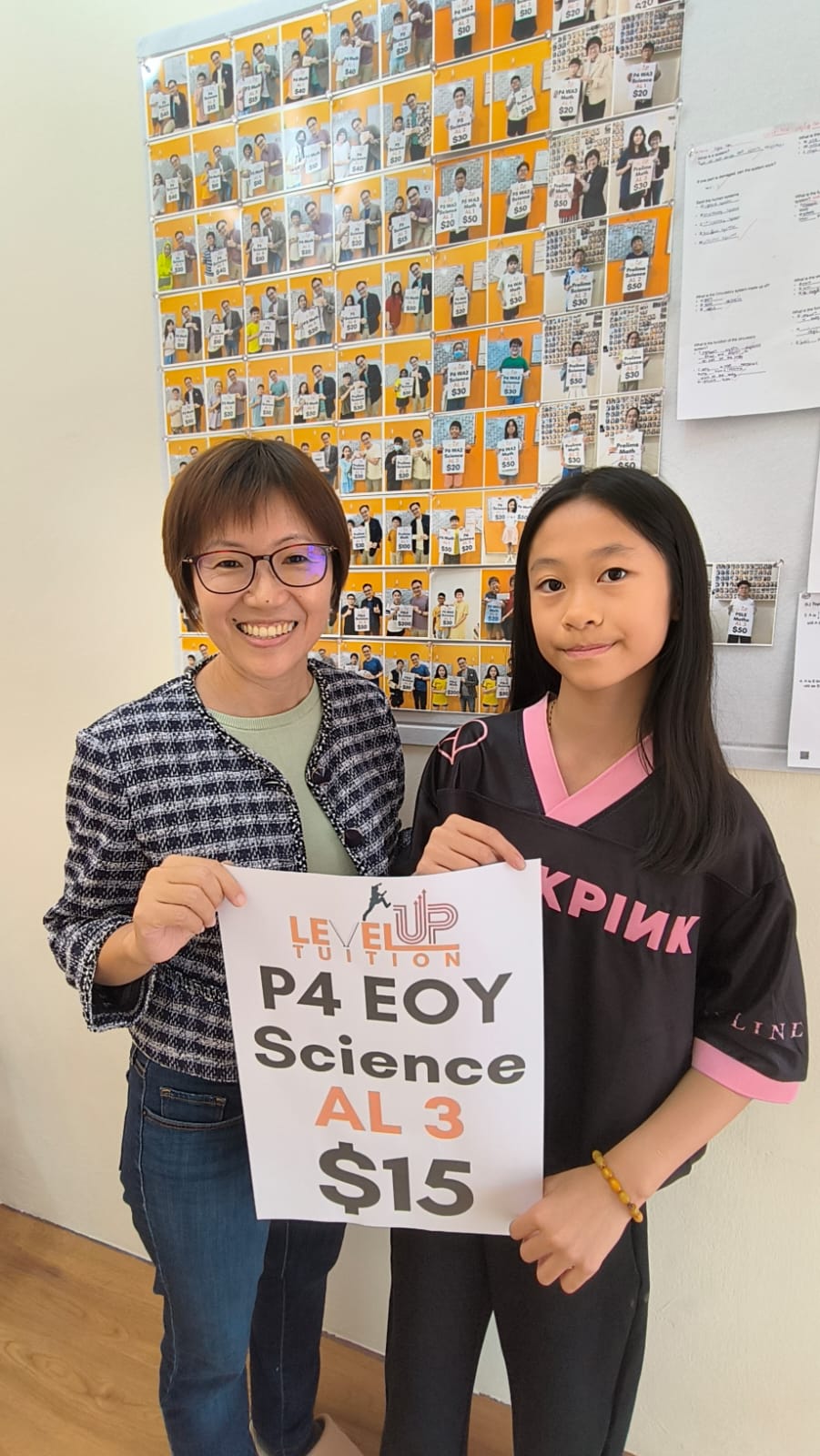 Chloe holding her LevelUp Tuition P4 EOY Science AL3 reward